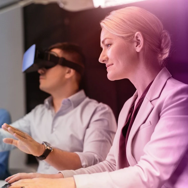 Young professionals experiment with augmented reality using vr visors.