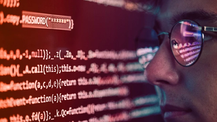 A male profile observes a digital screen containing strings of code related to software development.
